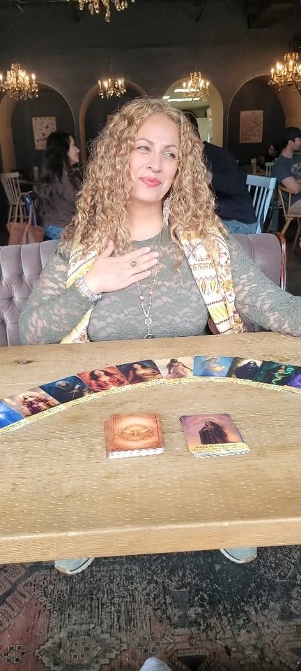 Natalia Love Angelou seated with her original oracle cards